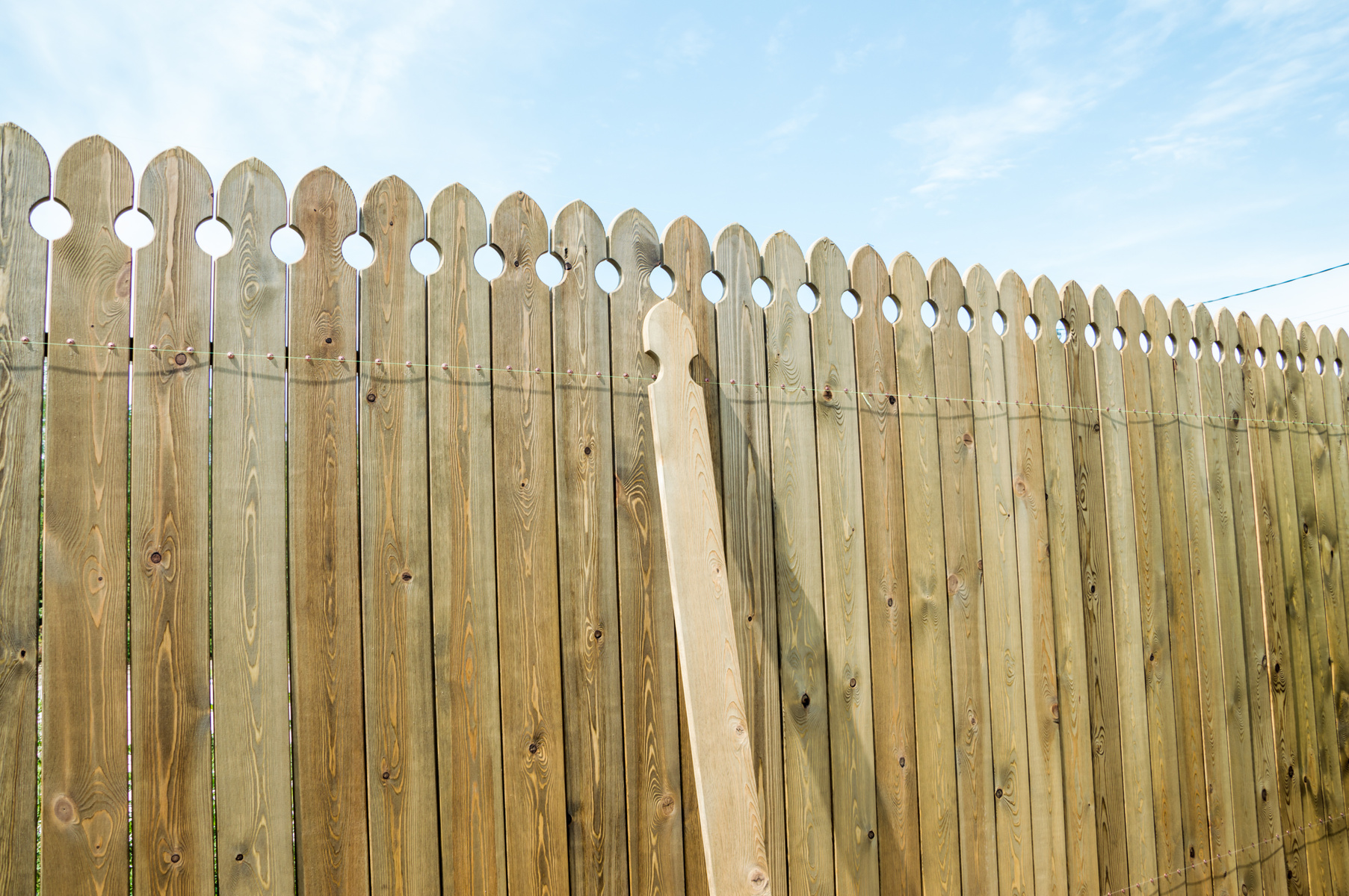 Installing a wooden fence.