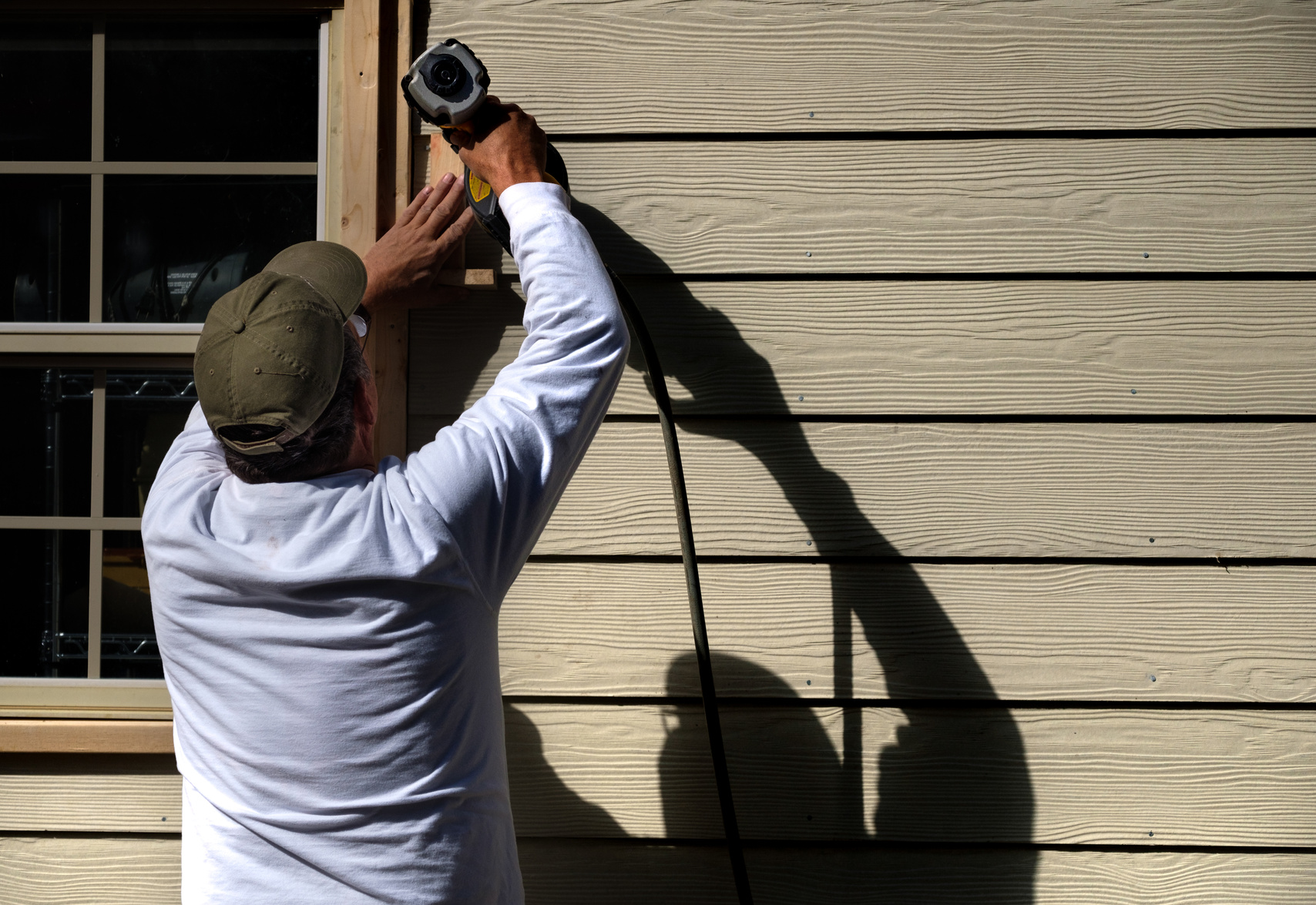 Carpenter Installing Siding