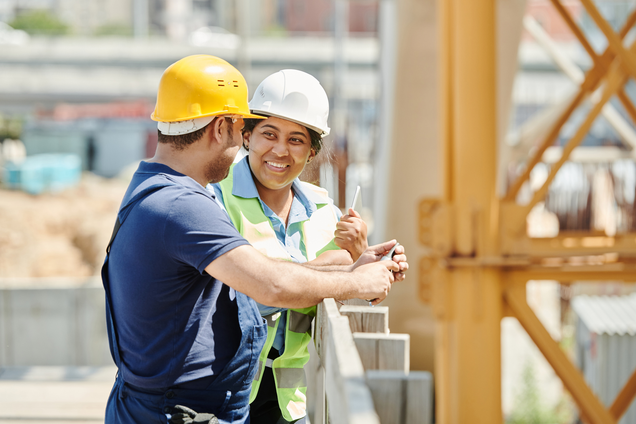 A Man and Woman Wearing Hard Hat While Talking